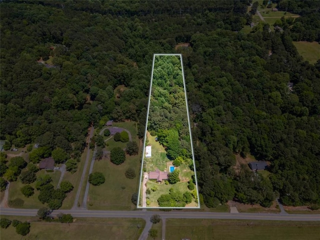 3769 Bay Creek Church Rd, Loganville, GA 30052 - aerial view of property and surrounding area featuring a forest and property parcel outlined