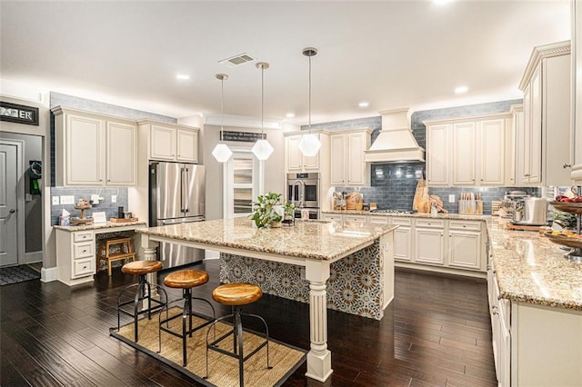 4435 Mossbrook Cir, Alpharetta, GA 30004 - kitchen with appliances with stainless steel finishes, premium range hood, dark wood-style floors, light stone countertops, and decorative backsplash