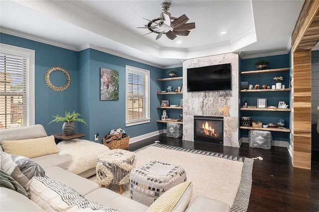 4435 Mossbrook Cir, Alpharetta, GA 30004 - living room featuring a ceiling fan, wood finished floors, a high end fireplace, a raised ceiling, and ornamental molding