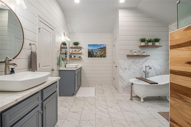 4435 Mossbrook Cir, Alpharetta, GA 30004 - bathroom with marble finish floors, two vanities, vaulted ceiling, a freestanding bath, and wooden walls