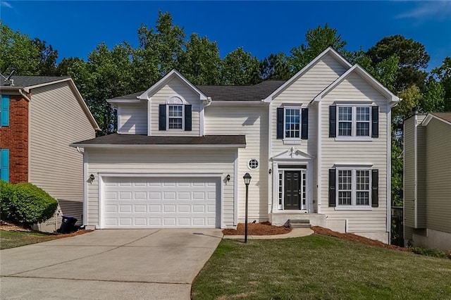 traditional-style home with an attached garage, driveway, and a front lawn