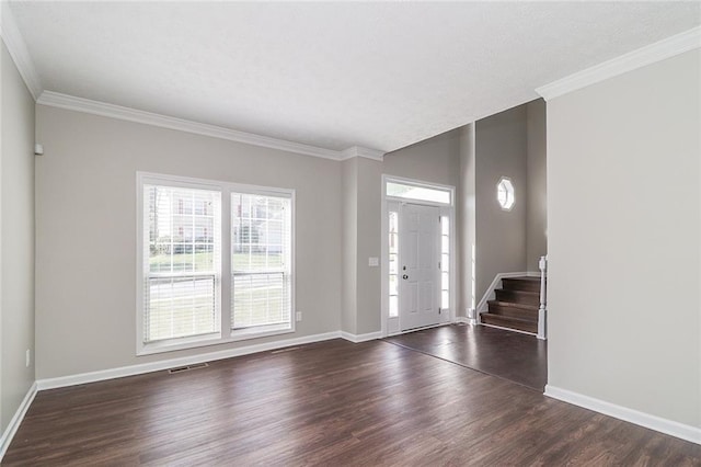 entryway with crown molding, baseboards, and dark wood-style flooring