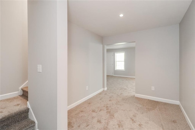 spare room with recessed lighting, carpet, stairs, and baseboards