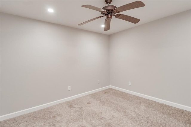 carpeted spare room featuring recessed lighting, baseboards, and ceiling fan