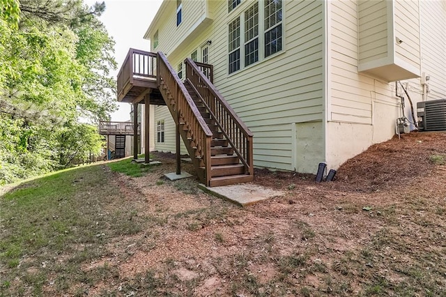 rear view of property featuring stairway, a wooden deck, and cooling unit