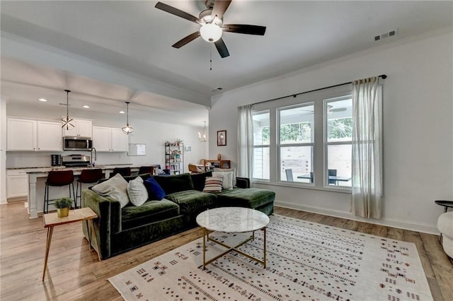 2129 Charmond Dr, Monroe, GA 30656 - living room featuring light wood-type flooring, ornamental molding, ceiling fan, and recessed lighting