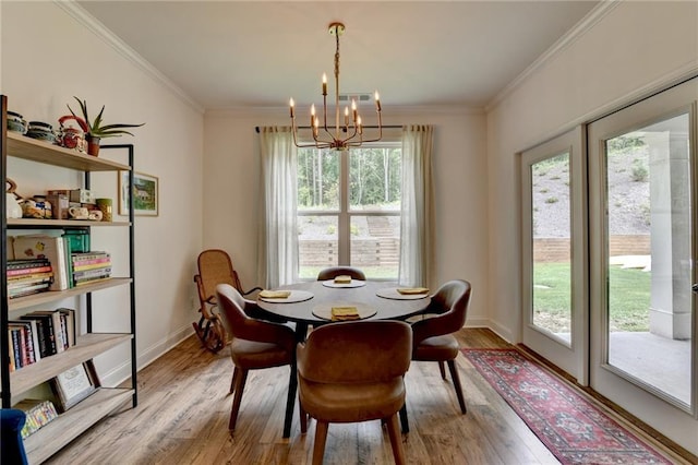 2129 Charmond Dr, Monroe, GA 30656 - dining space featuring a chandelier, wood finished floors, and ornamental molding