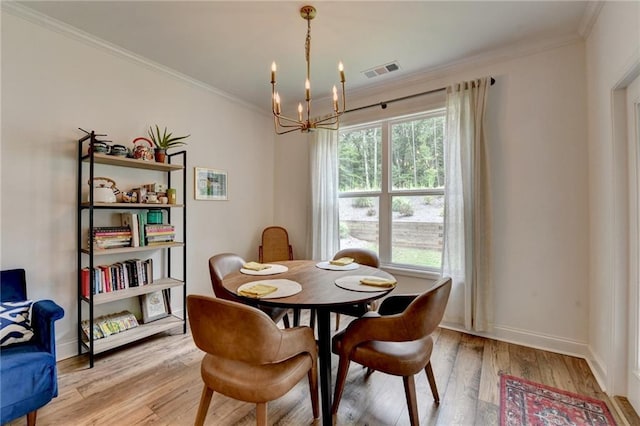2129 Charmond Dr, Monroe, GA 30656 - dining space with a chandelier, ornamental molding, and light wood finished floors