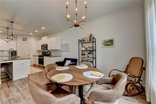 2129 Charmond Dr, Monroe, GA 30656 - dining room with recessed lighting, light wood-type flooring, a chandelier, and crown molding