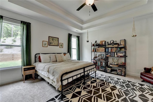 2129 Charmond Dr, Monroe, GA 30656 - carpeted bedroom with multiple windows, ornamental molding, a tray ceiling, and ceiling fan