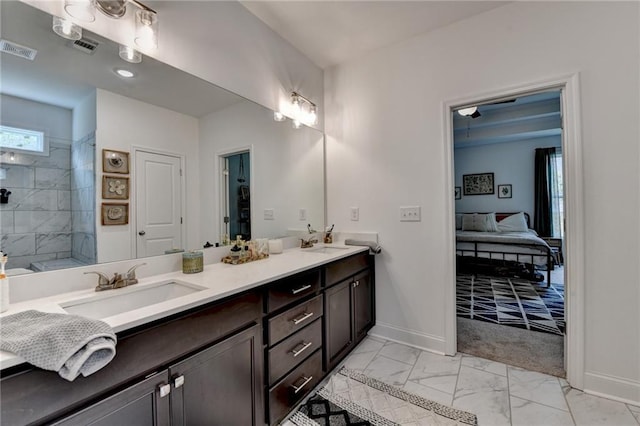 2129 Charmond Dr, Monroe, GA 30656 - ensuite bathroom with double vanity, marble finish floors, and tiled shower