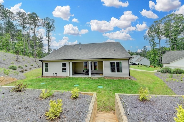 2129 Charmond Dr, Monroe, GA 30656 - back of house featuring a patio, a lawn, and a garden