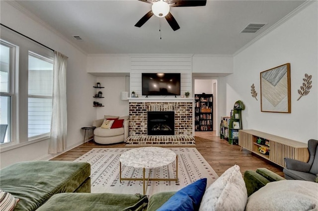 2129 Charmond Dr, Monroe, GA 30656 - living room with ceiling fan, crown molding, a fireplace, and wood finished floors