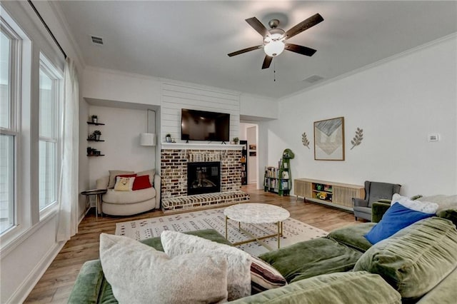 2129 Charmond Dr, Monroe, GA 30656 - living room with crown molding, ceiling fan, wood finished floors, and plenty of natural light