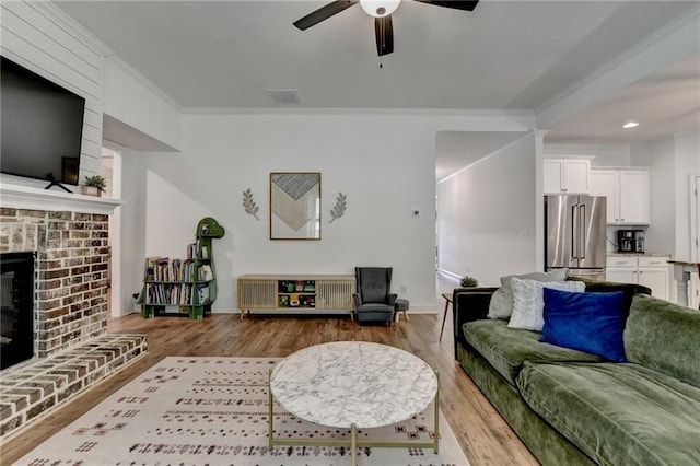 2129 Charmond Dr, Monroe, GA 30656 - living area featuring wood finished floors, ornamental molding, ceiling fan, a fireplace, and recessed lighting