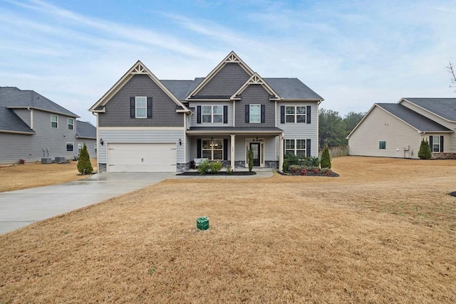 craftsman-style home with covered porch, concrete driveway, a front yard, and a garage