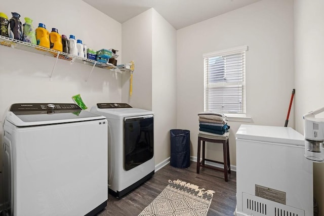 laundry room featuring dark wood finished floors, laundry area, independent washer and dryer, and baseboards