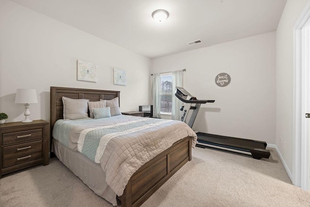 bedroom featuring light carpet, visible vents, and baseboards