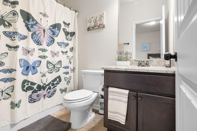 bathroom with a shower with curtain, tile patterned flooring, vanity, and toilet