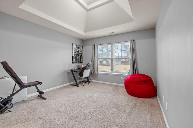 office space with carpet floors, baseboards, visible vents, and a raised ceiling