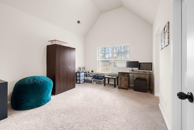 carpeted home office featuring high vaulted ceiling, baseboards, and visible vents