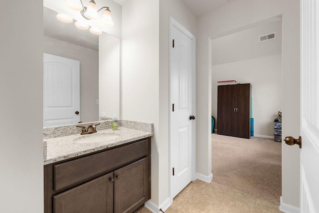 bathroom with baseboards, visible vents, tile patterned flooring, and vanity