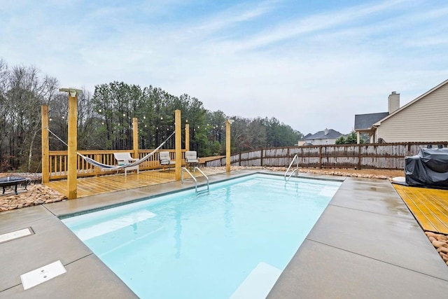 view of pool featuring a deck, fence, and a fenced in pool