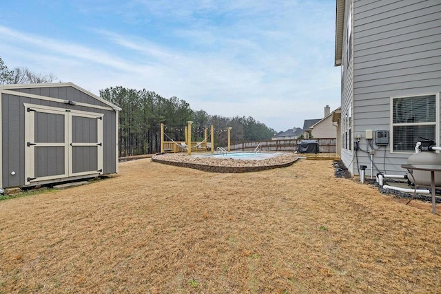 view of yard with a storage shed, an outdoor structure, and a fenced backyard