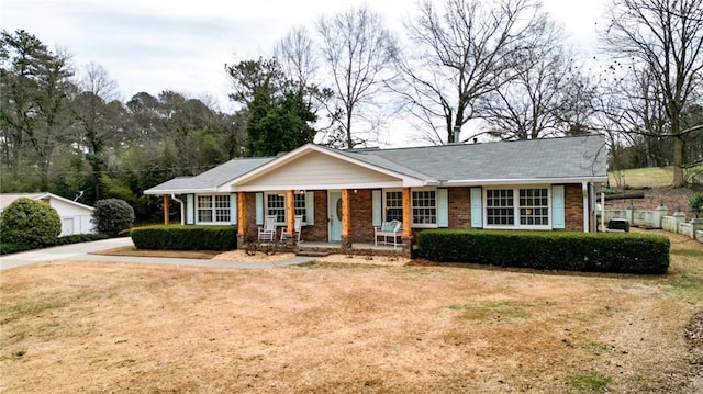 single story home with covered porch and a front lawn