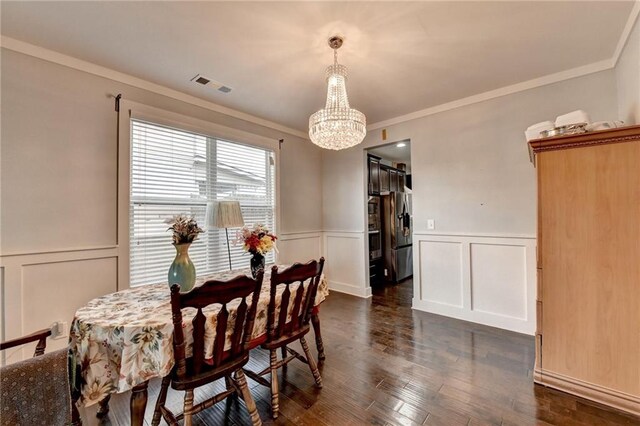 dining space featuring a notable chandelier, dark hardwood / wood-style floors, and ornamental molding