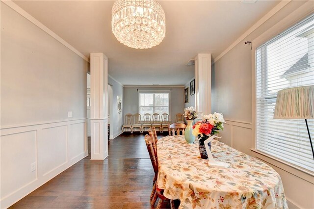 dining room with ornamental molding, dark wood-type flooring, and a notable chandelier