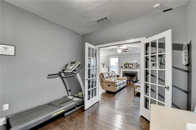 workout room featuring french doors, ceiling fan, and dark wood-type flooring