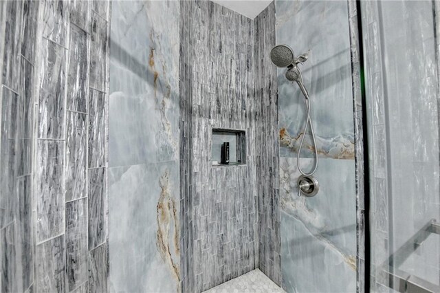 bathroom with tiled shower