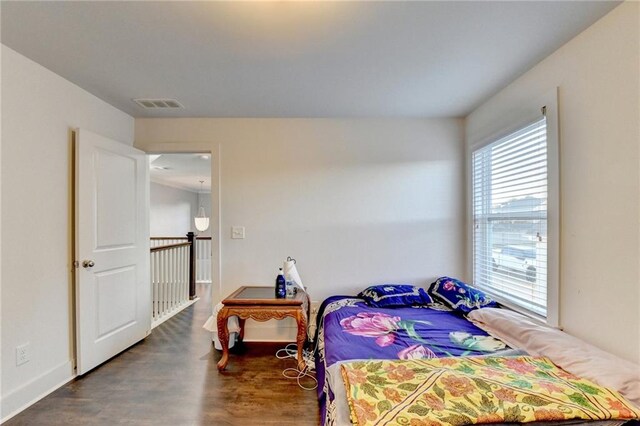 bedroom with dark hardwood / wood-style flooring