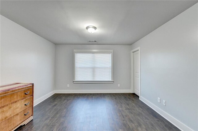 unfurnished room featuring dark wood-type flooring