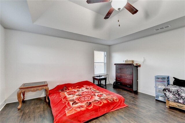 bedroom with dark hardwood / wood-style flooring and ceiling fan