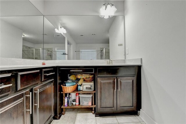 bathroom featuring tile patterned flooring, vanity, and an enclosed shower