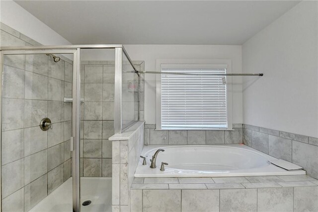 bathroom featuring separate shower and tub