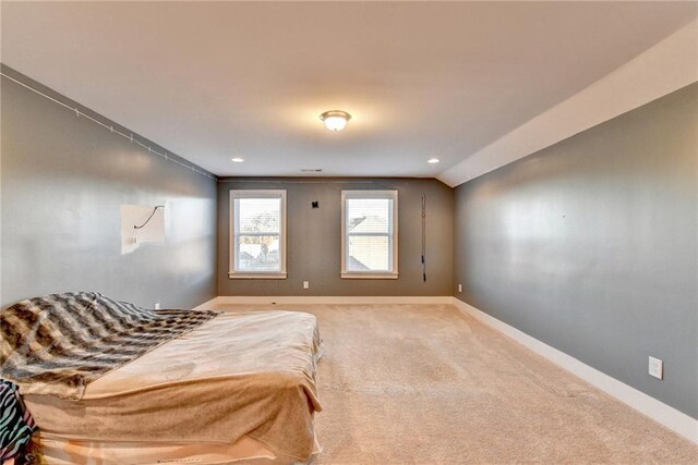 bedroom featuring carpet floors and vaulted ceiling