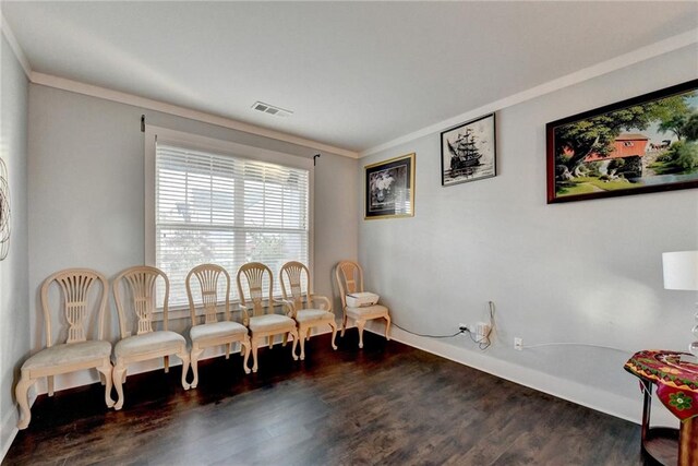 sitting room featuring crown molding and dark wood-type flooring