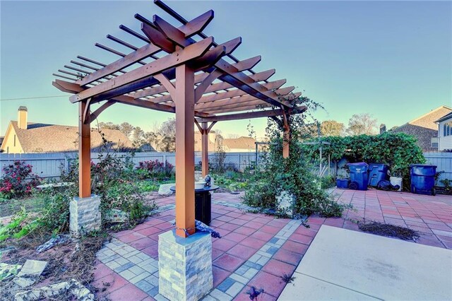 patio terrace at dusk featuring a pergola