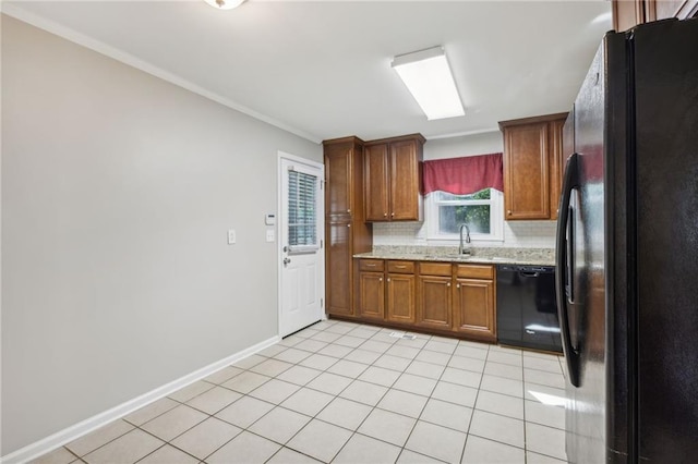 1231 Sanden Ferry Dr, Decatur, GA 30033 - kitchen with light tile patterned floors, baseboards, brown cabinets, black appliances, and backsplash