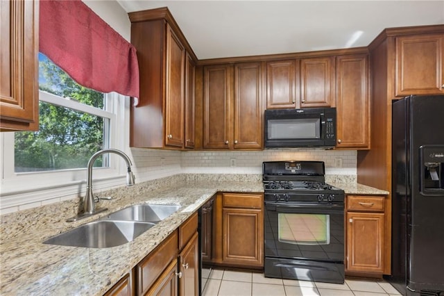 1231 Sanden Ferry Dr, Decatur, GA 30033 - kitchen with tasteful backsplash, a sink, light stone counters, and black appliances