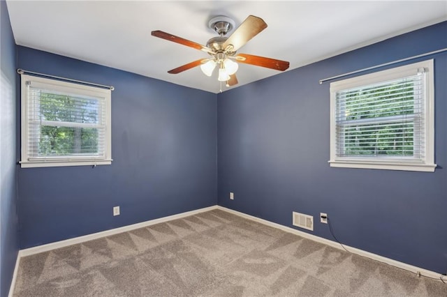 1231 Sanden Ferry Dr, Decatur, GA 30033 - carpeted empty room with baseboards, visible vents, and ceiling fan