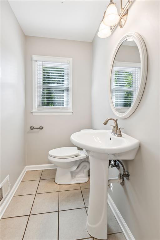 1231 Sanden Ferry Dr, Decatur, GA 30033 - half bath with visible vents, tile patterned flooring, toilet, and baseboards