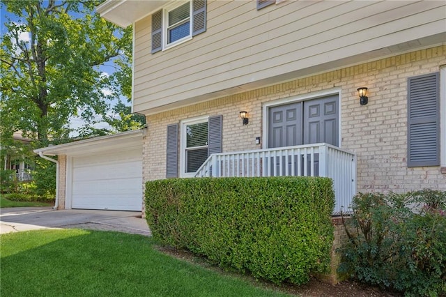 1231 Sanden Ferry Dr, Decatur, GA 30033 - doorway to property featuring driveway, brick siding, a lawn, and an attached garage