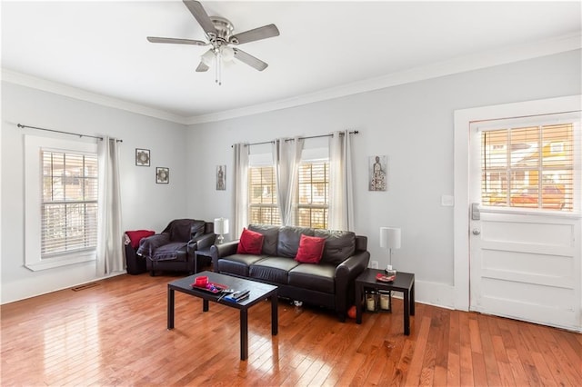 living room with ceiling fan, a healthy amount of sunlight, crown molding, and hardwood / wood-style floors