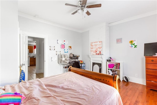 bedroom with ceiling fan, light wood-type flooring, and ornamental molding