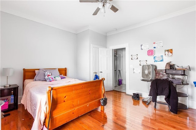 bedroom featuring ceiling fan, ornamental molding, and hardwood / wood-style flooring