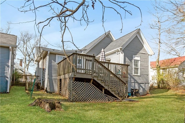 back of house featuring a lawn and a wooden deck